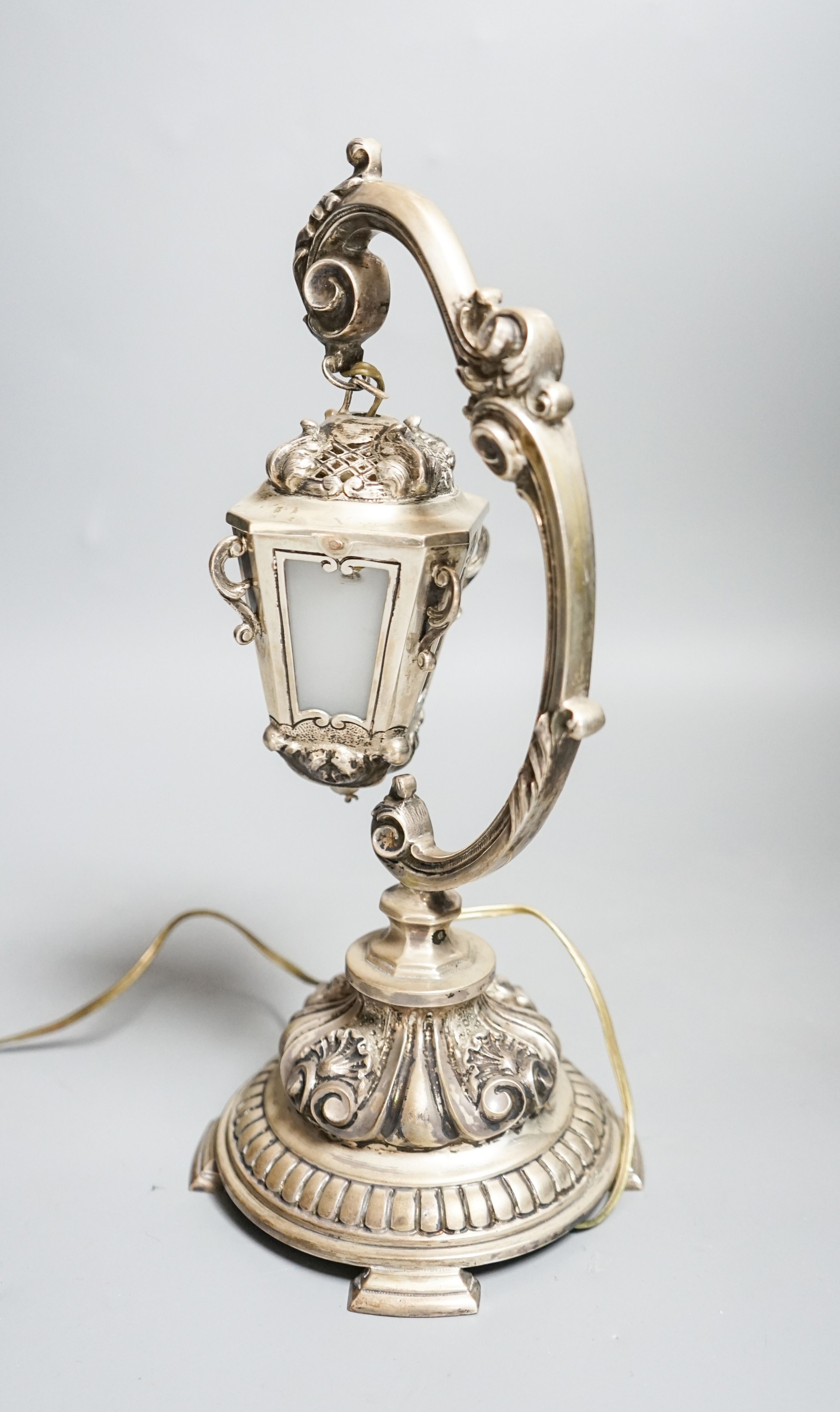 A Portuguese white metal table lamp modelled as a hanging lantern, height 28.1cm.